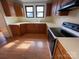 Functional kitchen featuring oak cabinets, white countertops and laminate flooring at 5135 Tucker Ave, Kannapolis, NC 28081