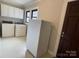 Bright laundry room with modern washer, dryer, and overhead cabinets at 5135 Tucker Ave, Kannapolis, NC 28081