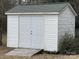 A vinyl sided storage shed with double doors and a ramp at 5135 Tucker Ave, Kannapolis, NC 28081