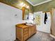 Classic bathroom with a wooden vanity, wainscoting, and large mirror at 528 Sherrill Ave, Lincolnton, NC 28092