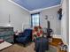 Small bedroom featuring wallpapered walls, and a blue accent chair at 528 Sherrill Ave, Lincolnton, NC 28092