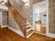 Hallway with hardwood floors, a wooden staircase, and access to another room at 528 Sherrill Ave, Lincolnton, NC 28092