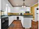 Bright kitchen with white cabinets, central island, and black countertops at 528 Sherrill Ave, Lincolnton, NC 28092