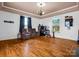 Spacious room showcasing hardwood floors, three recliners, and large windows at 528 Sherrill Ave, Lincolnton, NC 28092