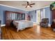 Comfortable bedroom with hardwood floors, a ceiling fan, and abundant natural light at 528 Sherrill Ave, Lincolnton, NC 28092