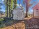 Old outdoor shed surrounded by trees and foliage at 528 Sherrill Ave, Lincolnton, NC 28092