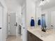 Bright bathroom vanity area showing tile floors, a white countertop, and dark cabinets at 702 Yucatan Dr, Waxhaw, NC 28173