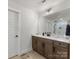 Bright bathroom featuring modern vanity, large mirror, and walk-in shower in background at 702 Yucatan Dr, Waxhaw, NC 28173