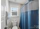 Cozy bathroom with a blue shower curtain and a white toilet at 702 Yucatan Dr, Waxhaw, NC 28173