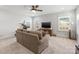 Bright bonus room with large windows and a comfortable couch for relaxation at 702 Yucatan Dr, Waxhaw, NC 28173