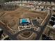 Aerial view of the community pool with clubhouse and playground in residential neighborhood at 702 Yucatan Dr, Waxhaw, NC 28173