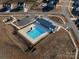 Aerial view of the community pool and clubhouse with parking at 702 Yucatan Dr, Waxhaw, NC 28173