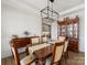 Elegant dining room featuring a dining table with seating, hutch, and modern chandelier at 702 Yucatan Dr, Waxhaw, NC 28173