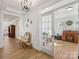 Open foyer with hardwood floors, leading to a bright office with glass door and decorative lights at 702 Yucatan Dr, Waxhaw, NC 28173