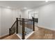 Second floor hallway featuring wood floors and banister overlooking an open concept layout at 702 Yucatan Dr, Waxhaw, NC 28173