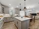 Open-concept kitchen featuring a large island and seamless flow into the dining area at 702 Yucatan Dr, Waxhaw, NC 28173