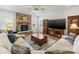 Living room showcasing a stone fireplace, large TV, and comfortable sofa for relaxation at 702 Yucatan Dr, Waxhaw, NC 28173