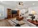 Cozy living room features hardwood floors, a large television and a neutral sofa at 702 Yucatan Dr, Waxhaw, NC 28173