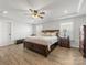 Luxurious main bedroom with hardwood floors, tray ceiling, and windows for natural light at 702 Yucatan Dr, Waxhaw, NC 28173