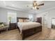 Spacious main bedroom featuring hardwood floors, ceiling fan, and ensuite bath access at 702 Yucatan Dr, Waxhaw, NC 28173