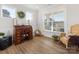 Cozy office featuring an antique desk, wicker chairs, and abundant natural light from large windows at 702 Yucatan Dr, Waxhaw, NC 28173
