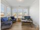 Bright sunroom filled with natural light, features cozy furniture and scenic views at 702 Yucatan Dr, Waxhaw, NC 28173