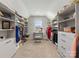 Well-organized walk-in closet featuring custom shelving, drawers, and natural light at 702 Yucatan Dr, Waxhaw, NC 28173