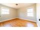 Bright bedroom features hardwood floors, neutral walls, and natural light from two windows at 7231 Lockmont Dr, Charlotte, NC 28212