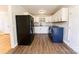 Contemporary kitchen featuring white cabinetry, modern appliances, and sleek flooring for a clean look at 7231 Lockmont Dr, Charlotte, NC 28212