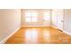 Sunlit living room boasts gleaming hardwood floors and neutral decor for versatile styling options at 7231 Lockmont Dr, Charlotte, NC 28212