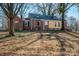 Lawn featuring a mix of grass and dirt areas with scattered trees behind the home at 801 Requa Rd, Cherryville, NC 28021