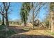 Lawn featuring a mix of grass and dirt areas with scattered trees behind the home at 801 Requa Rd, Cherryville, NC 28021