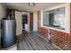 Basement with gray vinyl floors, brick walls, utility sink, and full bathroom at 801 Requa Rd, Cherryville, NC 28021