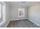 Cozy bedroom featuring light gray walls and flooring with bright windows at 801 Requa Rd, Cherryville, NC 28021