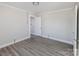 Bright bedroom featuring light gray walls and flooring with a glimpse into an adjacent room at 801 Requa Rd, Cherryville, NC 28021