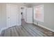 Bedroom featuring light gray walls and flooring with doors to hallway and closet at 801 Requa Rd, Cherryville, NC 28021