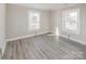 Bright bedroom featuring light gray walls and flooring with bright windows at 801 Requa Rd, Cherryville, NC 28021