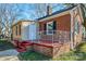 View of brick home with a white-railed side porch and red brick base at 801 Requa Rd, Cherryville, NC 28021