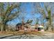Charming brick home with a cozy front porch and carport nestled under mature trees, perfect for curb appeal at 801 Requa Rd, Cherryville, NC 28021