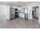 Modern kitchen with stainless steel appliances and white cabinets, seamlessly connected to the adjacent living space at 801 Requa Rd, Cherryville, NC 28021