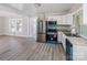 Open-concept kitchen featuring new appliances and countertops, flowing seamlessly into the light-filled living area at 801 Requa Rd, Cherryville, NC 28021
