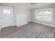 Bright living room featuring new flooring, fresh paint, and a charming fireplace creating a cozy atmosphere at 801 Requa Rd, Cherryville, NC 28021