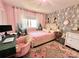 Pink bedroom with decorative wallpaper, cute furniture, and lots of natural light at 9009 Cebu Ct, Fort Mill, SC 29708
