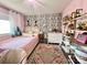 Stylish pink bedroom with a leaf-patterned wall, modern decor, and a bright, inviting atmosphere at 9009 Cebu Ct, Fort Mill, SC 29708