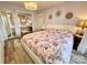 Bright bedroom with a crystal chandelier, mirrored closet doors, and decorative wall art at 9009 Cebu Ct, Fort Mill, SC 29708