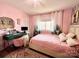 Cozy pink bedroom featuring a workspace, charming decor, and plenty of natural light at 9009 Cebu Ct, Fort Mill, SC 29708