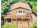 Charming cabin featuring a cozy deck, wood siding, and a scenic, wooded backdrop at 9009 Cebu Ct, Fort Mill, SC 29708