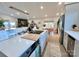 Modern kitchen featuring white countertops, stainless steel appliances, and an open view to living and dining areas at 9009 Cebu Ct, Fort Mill, SC 29708