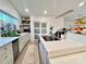 Bright, white kitchen featuring an island with a cooktop, ample counter space, and modern appliances at 9009 Cebu Ct, Fort Mill, SC 29708