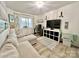 Cozy living room with sectional sofa, decorative shelving, and a window with natural light at 9009 Cebu Ct, Fort Mill, SC 29708